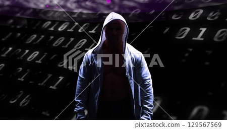 Image of binary coding and data processing over male hacker in hoodie 129567569