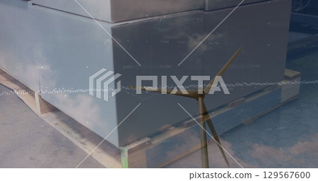 Image of wind turbine and warehouse over data processing 129567600