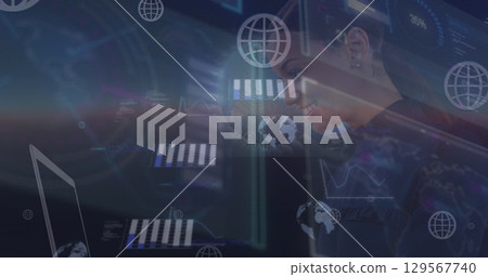 Image of moving graphs and computer network icons over happy businesswoman using laptop 129567740