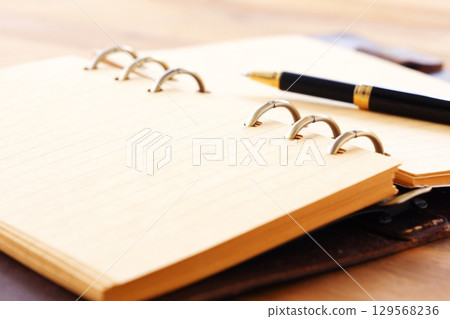 Image of a ring-type system organizer open while doing desk work Image of a ring-type system organizer open while doing desk work 129568236