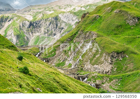 Grossglockner, Austria Alpine Waterfalls Carving Through Lush Green Mountain Slopes 129568350