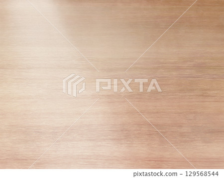 A background image of a delicate white wood grain desk with light shining diagonally from the upper left A background image of a delicate white wood grain desk with light shining diagonally from the upper left 129568544