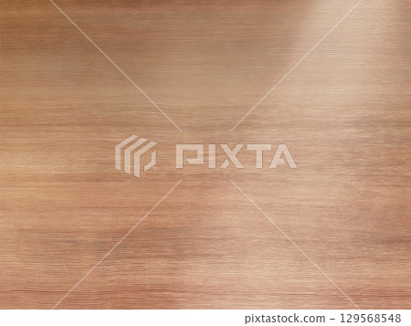 A background image of a delicate light brown wooden desk with light shining diagonally from the top right 129568548
