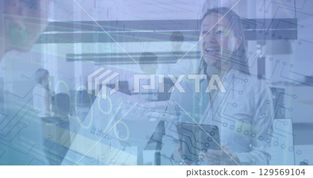 Image of numbers and loading over diverse female coworkers in office 129569104