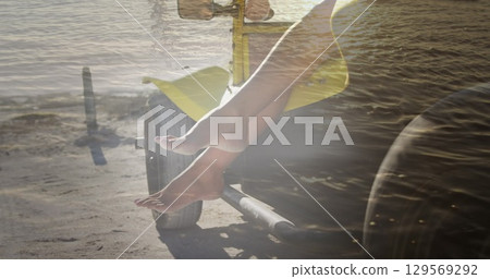 Image of legs of african american woman in car on beach 129569292