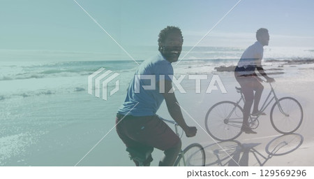 Image of african american man cycling over african american man cycling at beach Image of african american man cycling over african american man cycling at beach 129569296