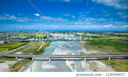 The Kurobe River in the Kurobe River alluvial fan, the Hokuriku Shinkansen viaduct, the Hokuriku Expressway, and other roads in summer 129569457