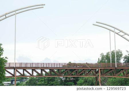 Modern bridge design against a cloudy sky with trees in the foreground. Mangrove Forest Learning Center Phra Chedi Klang Nam Rayong Thailand 129569723