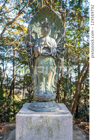 Buddhist statue surrounded by trees in nature at Engyoji mountain Shosha, Himeji, Japan 129569792