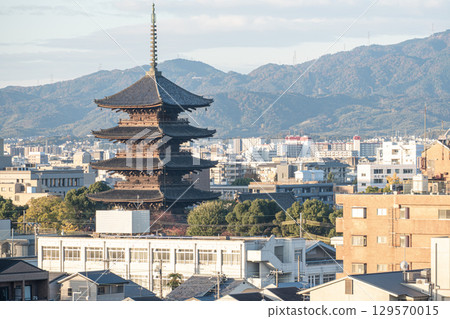 Five story Pagoda of Toji Temple in Kyoto, Historic pagoda amidst urban skyline and mountains Five story Pagoda of Toji Temple in Kyoto, Historic pagoda amidst urban skyline and mountains 129570015
