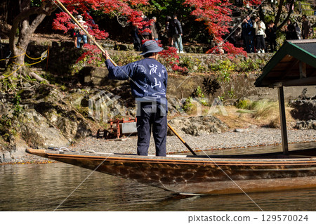 Scenic boat ride among autumn foliage at Hozugawa River 129570024