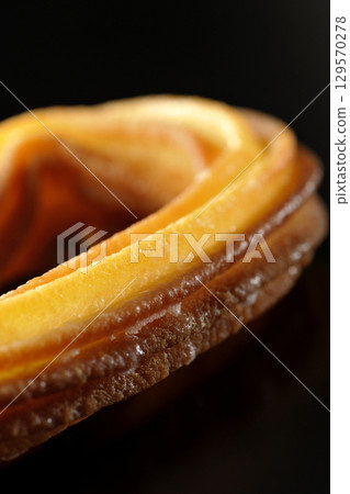 Churros photographed against a black background 129570278