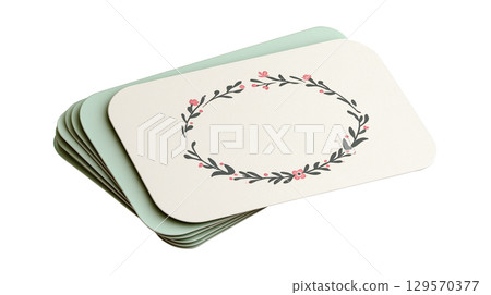 A stack of blank wedding invitation or place cards with a delicate floral wreath design and copy space 129570377