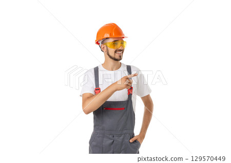 Worker in hard hat and goggles gestures, isolated on white, PNG 129570449