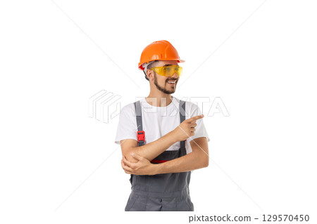 Cheerful worker in safety gear points, isolated on white, PNG 129570450