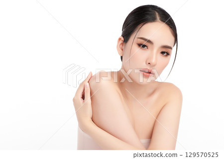A beautiful young Asian woman with clean, fresh skin against a white background. Skincare, facial treatment, cosmetology, beauty, and spa. An elegant portrait of an Asian woman. A beautiful young Asian woman with clean, fresh skin against a white background. Skincare, facial treatment, cosmetology, beauty, and spa. An elegant portrait of an Asian woman. 129570525