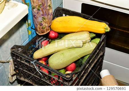 Vegetables ready for cooking are lying in the kitchen. Vegetables ready for cooking are lying in the kitchen. 129570691