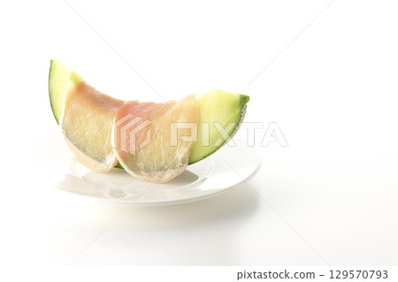 Raw ham and melon photographed on a white background 129570793