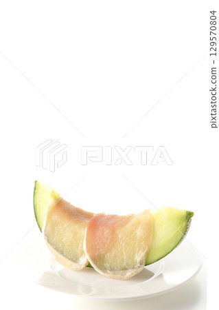 Raw ham and melon photographed on a white background 129570804