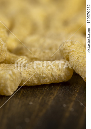 corn sticks made from flour, a large number of corn sticks for eating or making breakfast with milk. corn sticks on a wooden board corn sticks made from flour, a large number of corn sticks for eating or making breakfast with milk. corn sticks on a wooden board 129570982