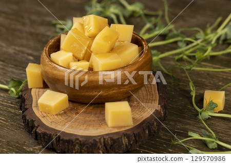 yellow cheese and honey closeup, fresh cheese and viscous sweet natural bee honey 129570986
