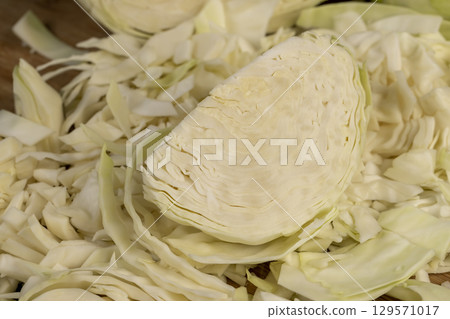 details of fresh cabbage chopped into small pieces for convenience of cooking, close up, white cabbage after washing during cooking details of fresh cabbage chopped into small pieces for convenience of cooking, close up, white cabbage after washing during cooking 129571017