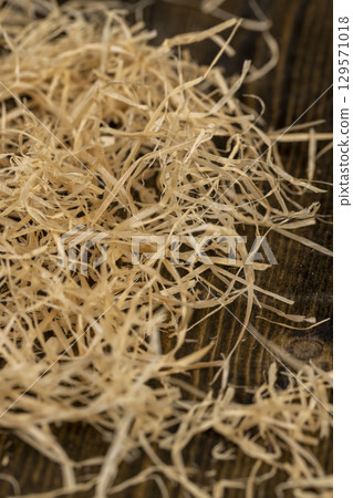 natural sawdust from wood and for decorative and creative work of artisans or gift wrapping, close up natural sawdust from wood and for decorative and creative work of artisans or gift wrapping, close up 129571018