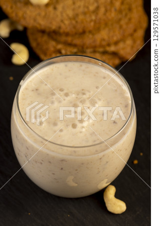 crunchy cookies and a glass of yogurt with prunes, a light breakfast of oatmeal cookies and a glass of yogurt crunchy cookies and a glass of yogurt with prunes, a light breakfast of oatmeal cookies and a glass of yogurt 129571038