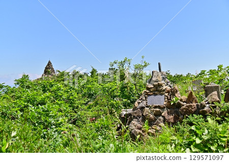 The memorial monument for the victims of the Jizo statue at the head of the statue of Jizo in fresh green and the Jizo cairn visible beyond it 129571097