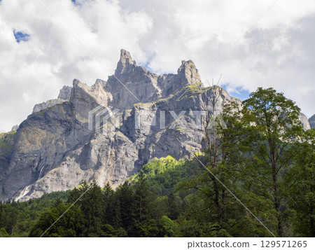 Fer-a-cheval, France - September 3rd 2024: View from the plain of Pelly towards the rocky Mont Ruan massif. 129571265