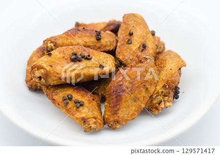 Crispy fried chicken wings on a white plate 129571417