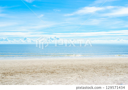 Sunny beach with clear blue sky and calm sea. Sunny beach with clear blue sky and calm sea. 129571434