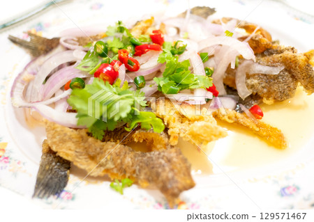 Spicy Crispy Gourami Fish salad with green mango, Thai food Spicy Crispy Gourami Fish salad with green mango, Thai food 129571467