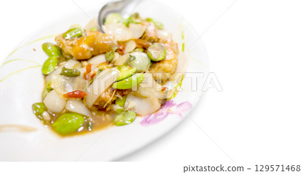Stir-Fried Twisted Cluster Bean, Thai food on a white plate. 129571468
