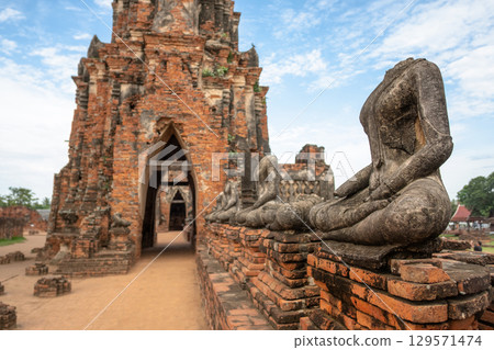Wat Chaiwatthanaram temple, Ayutthaya historical park, Ayutthaya, Thailand Ancient temple with weathered statues and brickwork 129571474