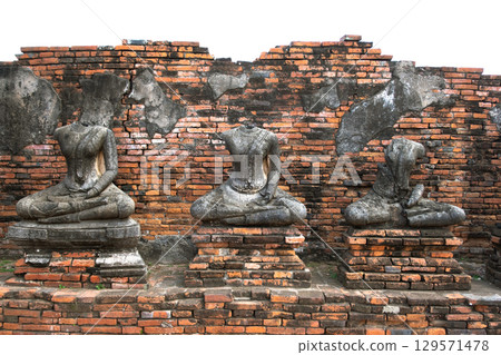 Wat Chaiwatthanaram temple, Ayutthaya historical park, Ayutthaya, Thailand Ancient Buddha statues against a brick wall 129571478