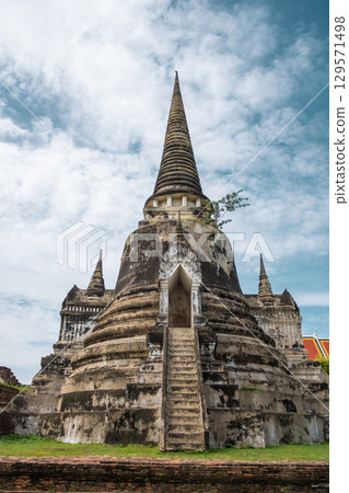 Wat Phra Si Sanphet, Ayutthaya historical park, Ayutthaya, Thailand Ancient temple with tall spires and cloudy sky 129571498