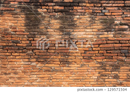 Old weathered brick wall texture with stains 129571504