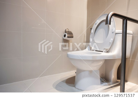 Toilet and handrail for elderly people at the toilet room in hospital, safety and medical concept Toilet and handrail for elderly people at the toilet room in hospital, safety and medical concept 129571537