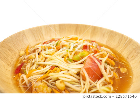 Som Tum Thai Bowl of Green papaya salad with shrimp, peanuts, lime, tomatoes Traditional Thai food in wooden bowl Som Tum Thai Bowl of Green papaya salad with shrimp, peanuts, lime, tomatoes Traditional Thai food in wooden bowl 129571540