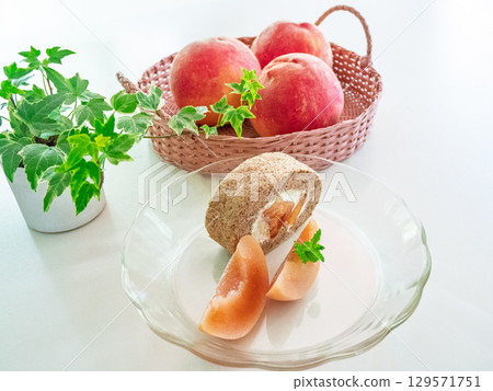 Peach tea roll cake, peaches, herbs, and ornamental plants 129571751