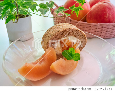 Peach tea roll cake, peaches, herbs, and ornamental plants Peach tea roll cake, peaches, herbs, and ornamental plants 129571755