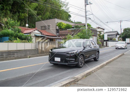 HEV compact SUV driving on the road 129571982