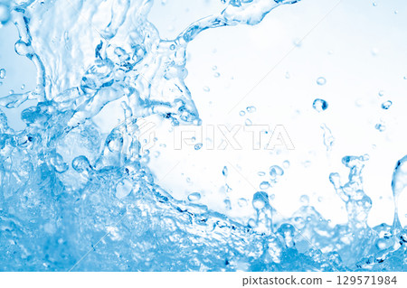 Water splashes on a blue background. Water splashes on a blue background. 129571984