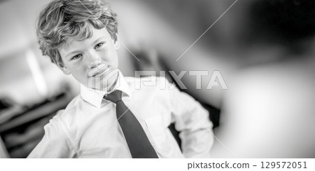 Confident Young Boy in Formal Attire Confident Young Boy in Formal Attire 129572051