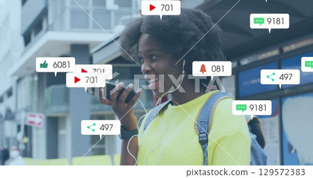 Image of social media icons with numbers over african american woman talking on smartphone Image of social media icons with numbers over african american woman talking on smartphone 129572383