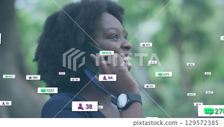 Image of network of connections with media icons over woman using smartphone Image of network of connections with media icons over woman using smartphone 129572385