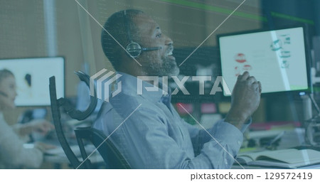 Image of data processing over african american senior man talking on phone headset at office Image of data processing over african american senior man talking on phone headset at office 129572419