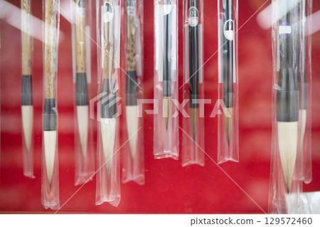 Many calligraphy brushes 129572460