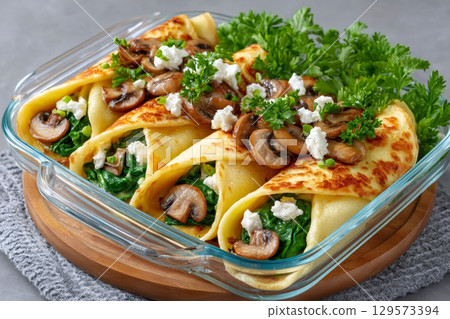 Delicious savory filled with spinach, mushrooms and goat cheese, garnished with fresh parsley Delicious savory filled with spinach, mushrooms and goat cheese, garnished with fresh parsley 129573394